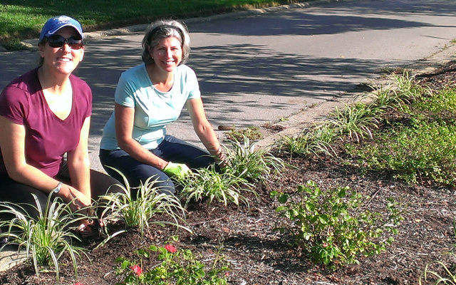 Beth Ruggles and Leslie Russ planting liriope at the front entrance.